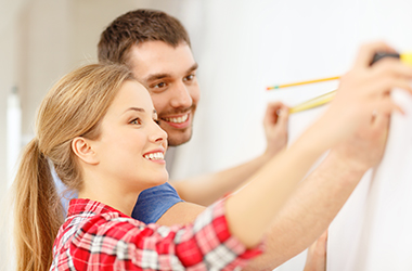 Young Couple measuring room size